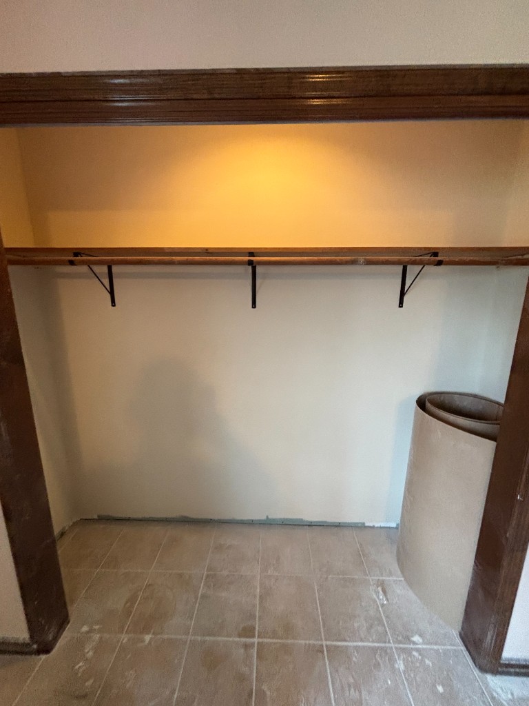 Custom wood closet shelf on black brackets