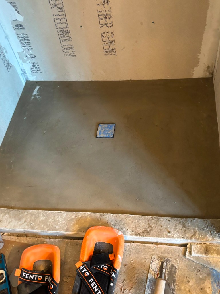 Shower mud bed and curb with tools on site